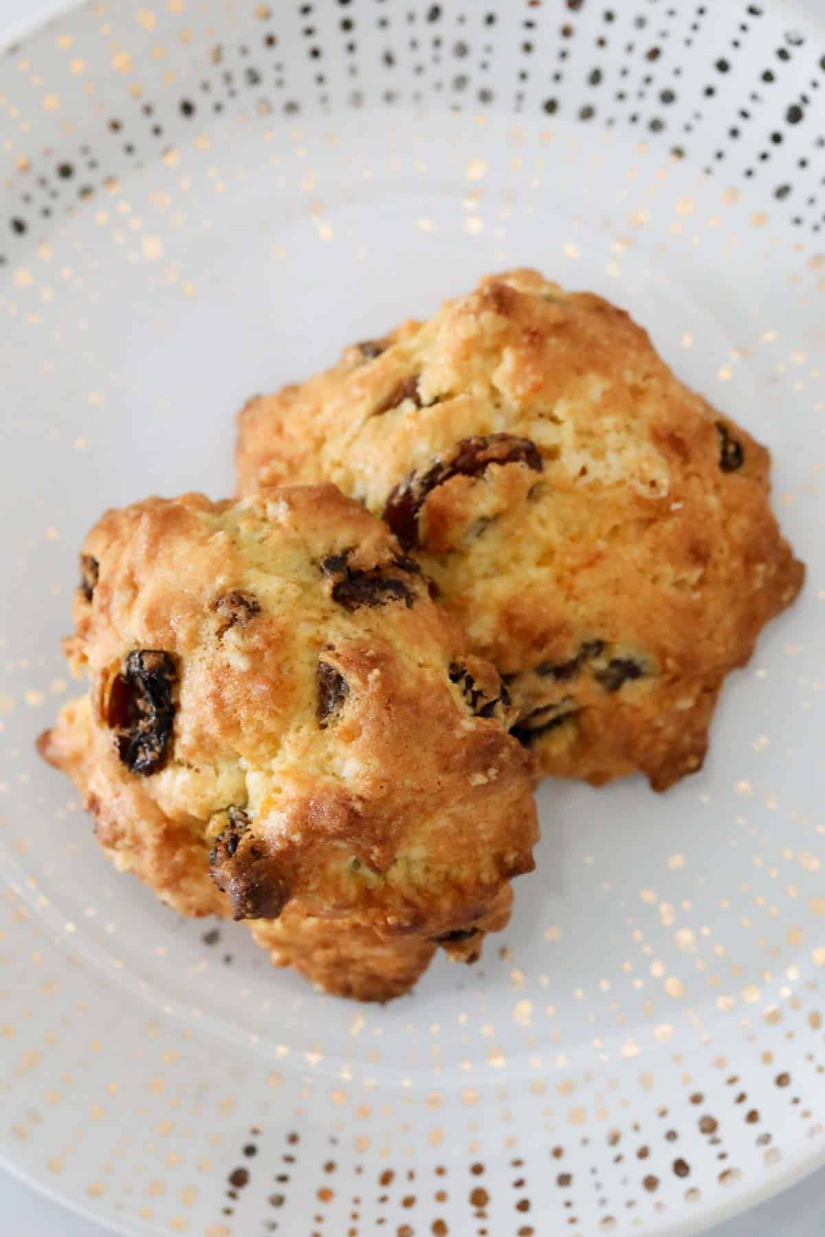 Looking down on two rock cakes on a white plate.