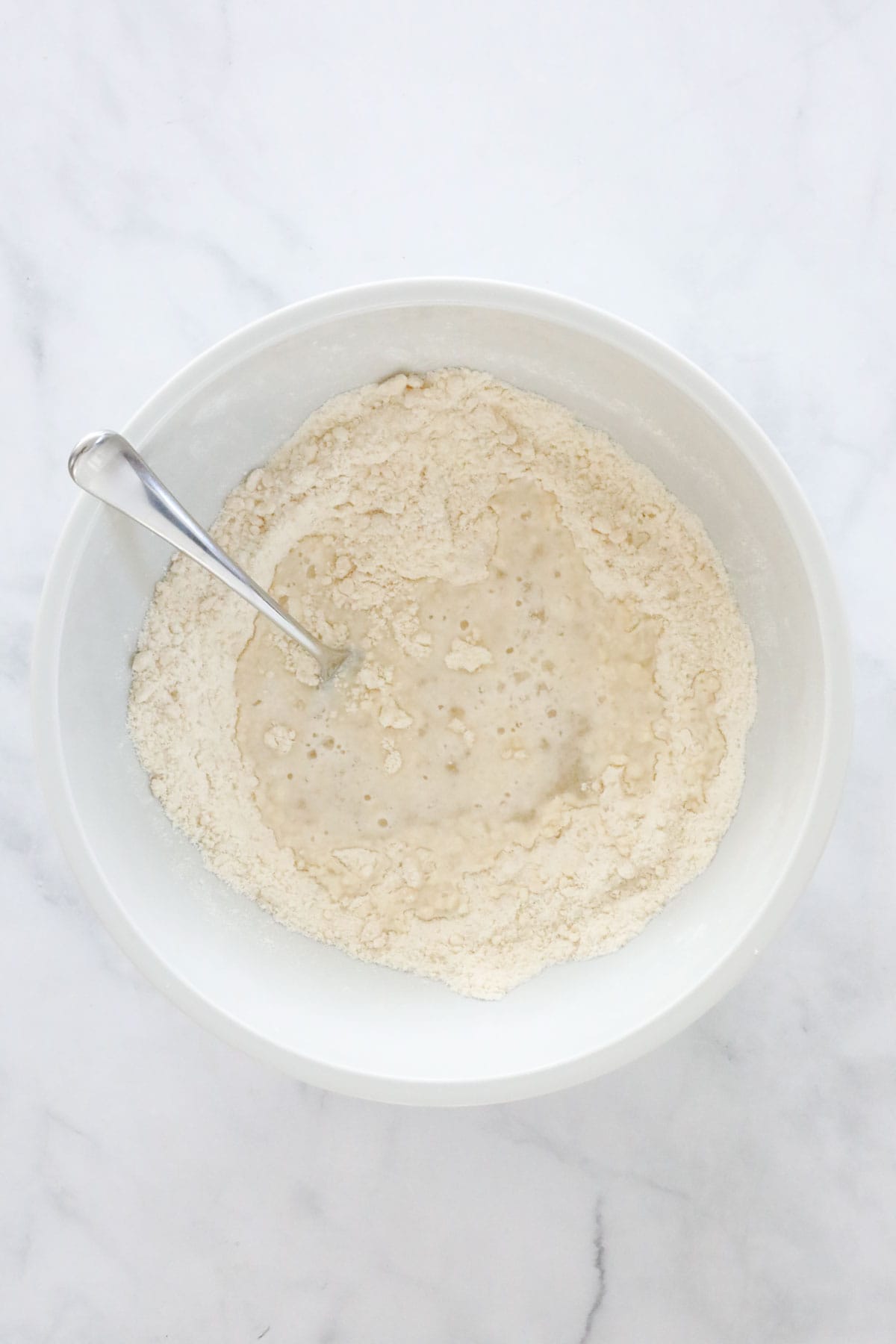 Warm water poured into the flour mixture.