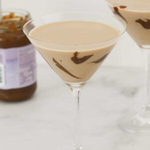 A martini glass filled with a creamy salted caramel cocktail.