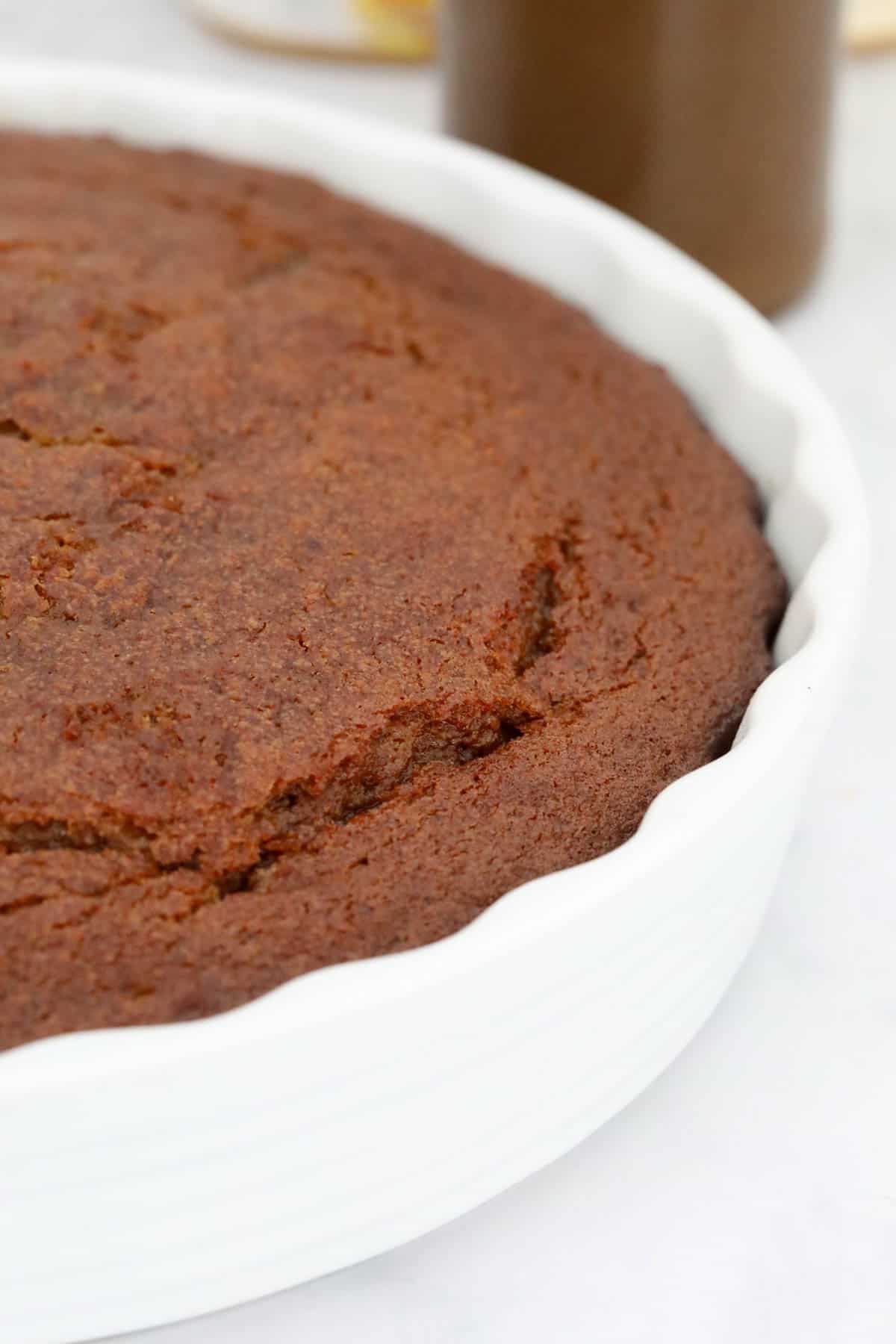 Baked date pudding in a round white baking dish.