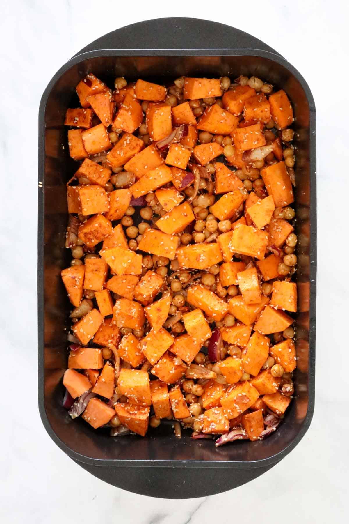 The sweet potato and chickpeas thoroughly coated in the seasonings and sesame seeds.