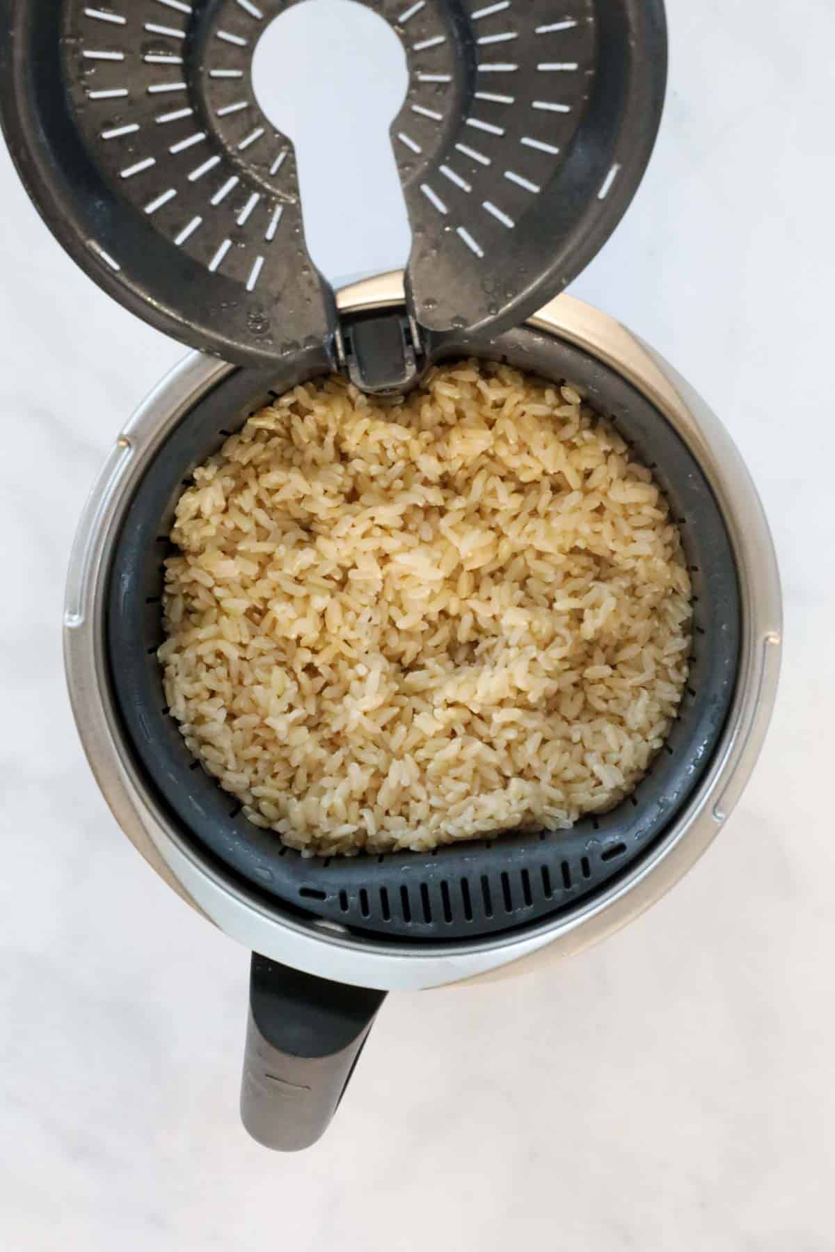 An overhead shot of brown rice in a Thermomix machine.