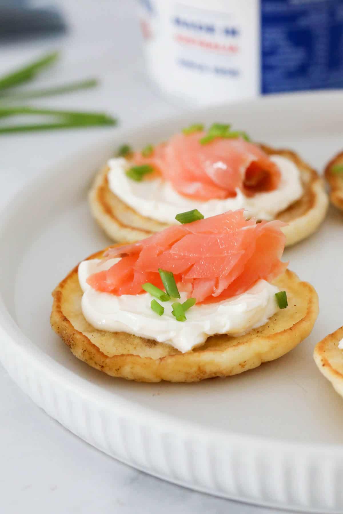 Blimis with smoked salmon served on a platter.