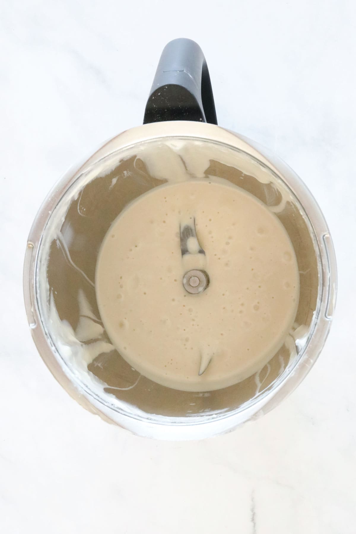 Blended Caesar dressing in a Thermomix jug.