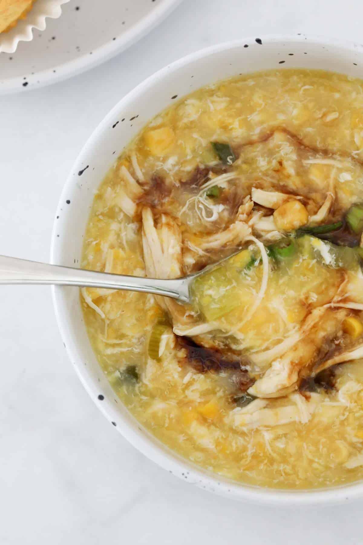 An overhead shot of Chinese egg drop soup with soy sauce.