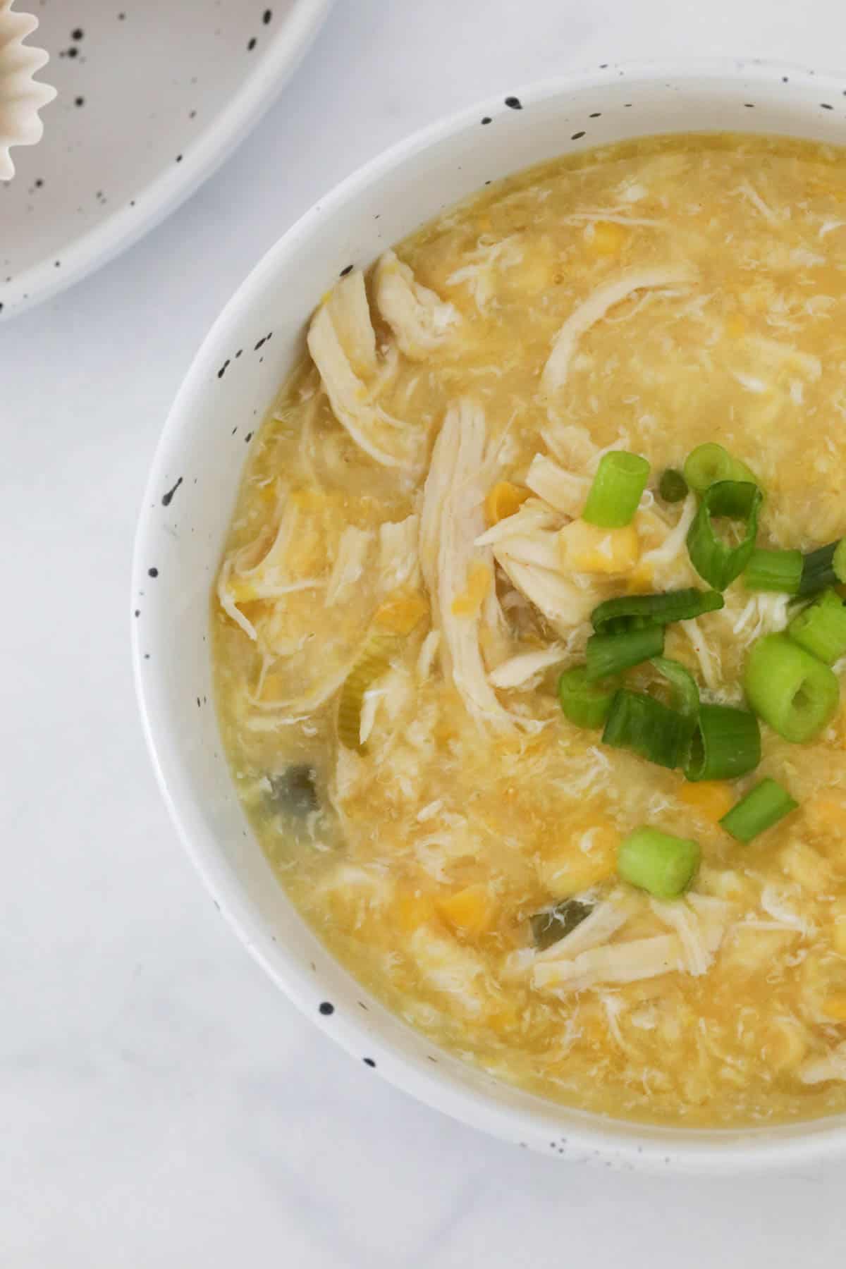 An overhead shot of Chinese corn and chicken soup.