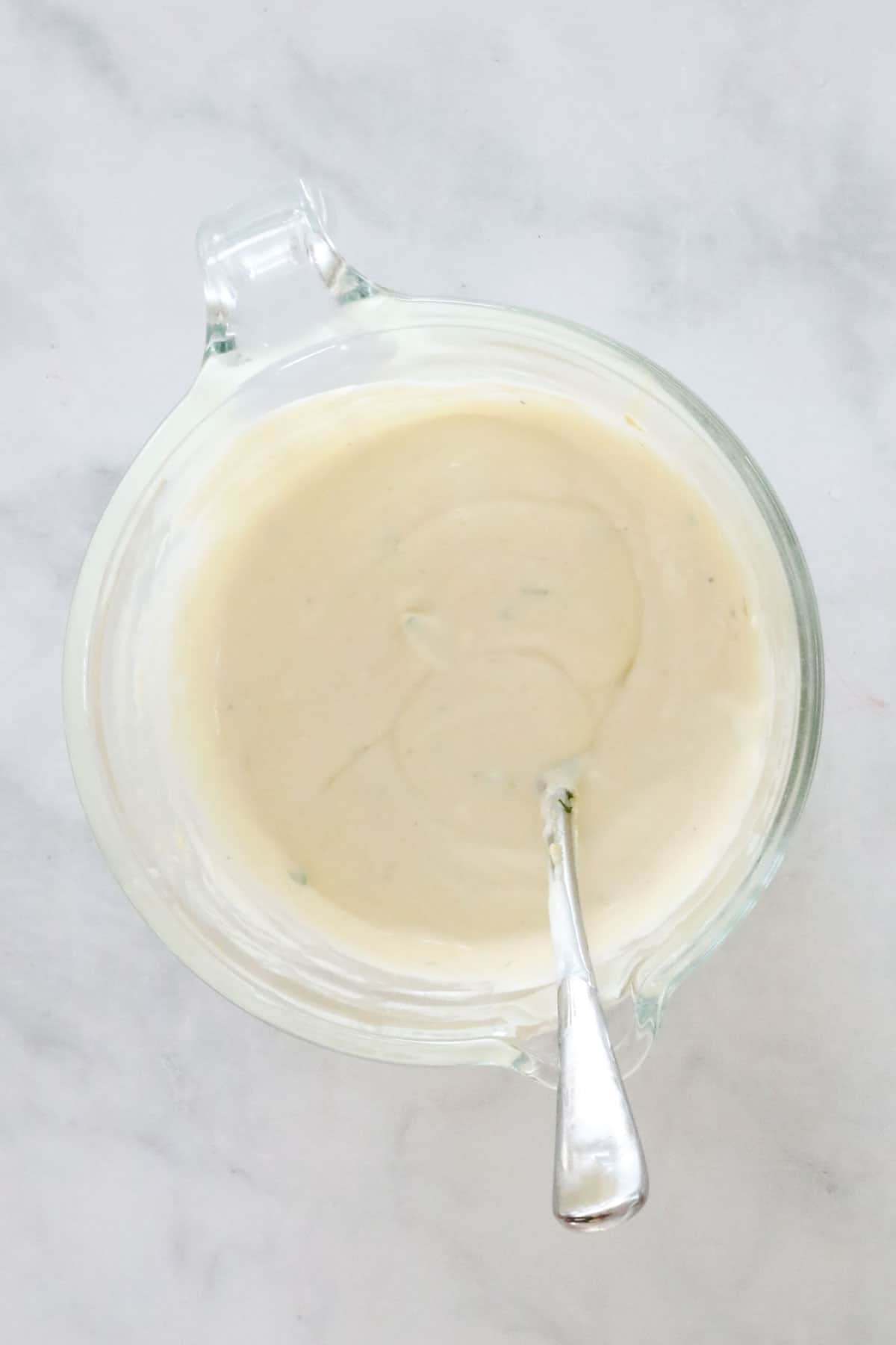 The combined creamy dressing in the jug.