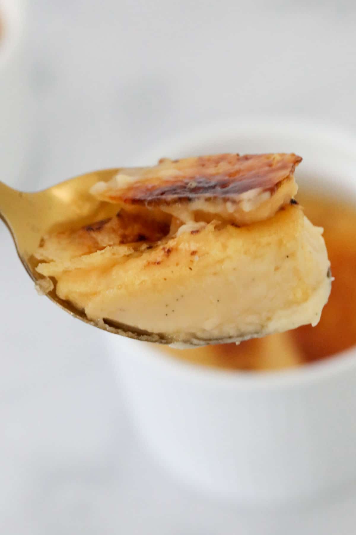 Close up of a spoonful of creme brûlée.