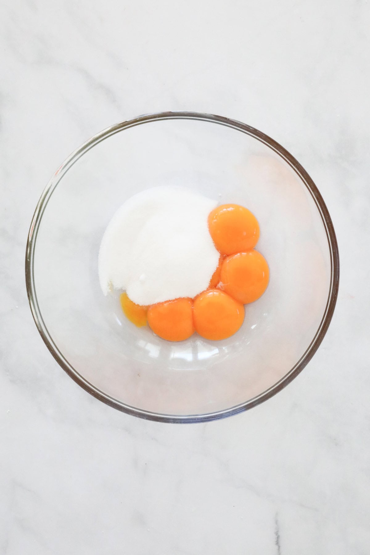 Egg yolks and caster sugar in a bowl.