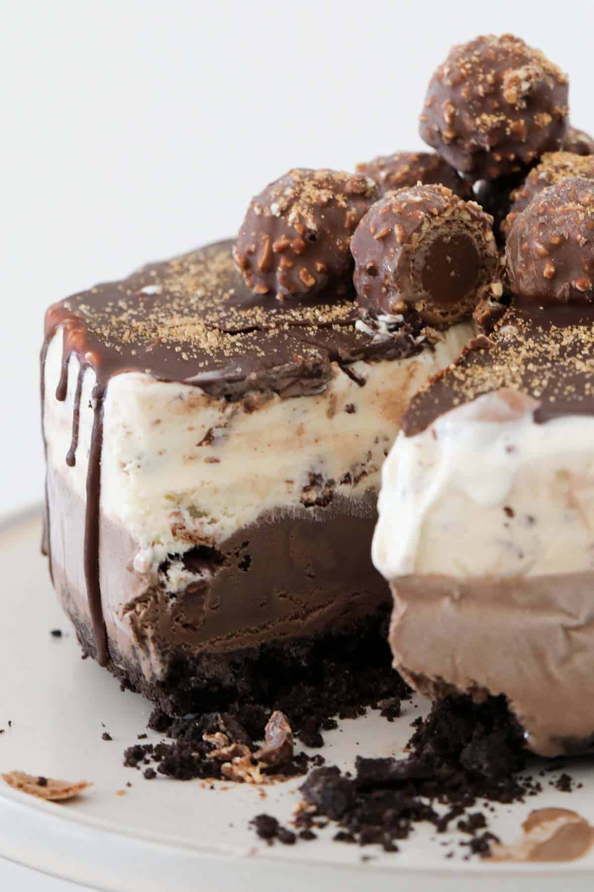 Ferrero Rocher Ice Cream Cake with a slice cut out to show the layers.