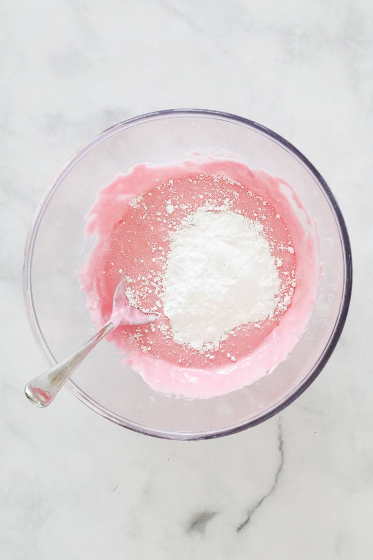 Icing sugar sifted into the melted pink marshmallow mixture.