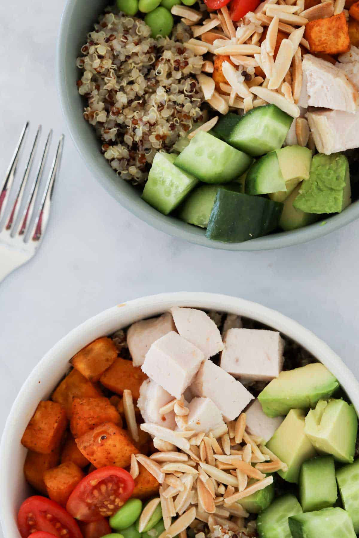 Two prepared quinoa chicken salad bowls.