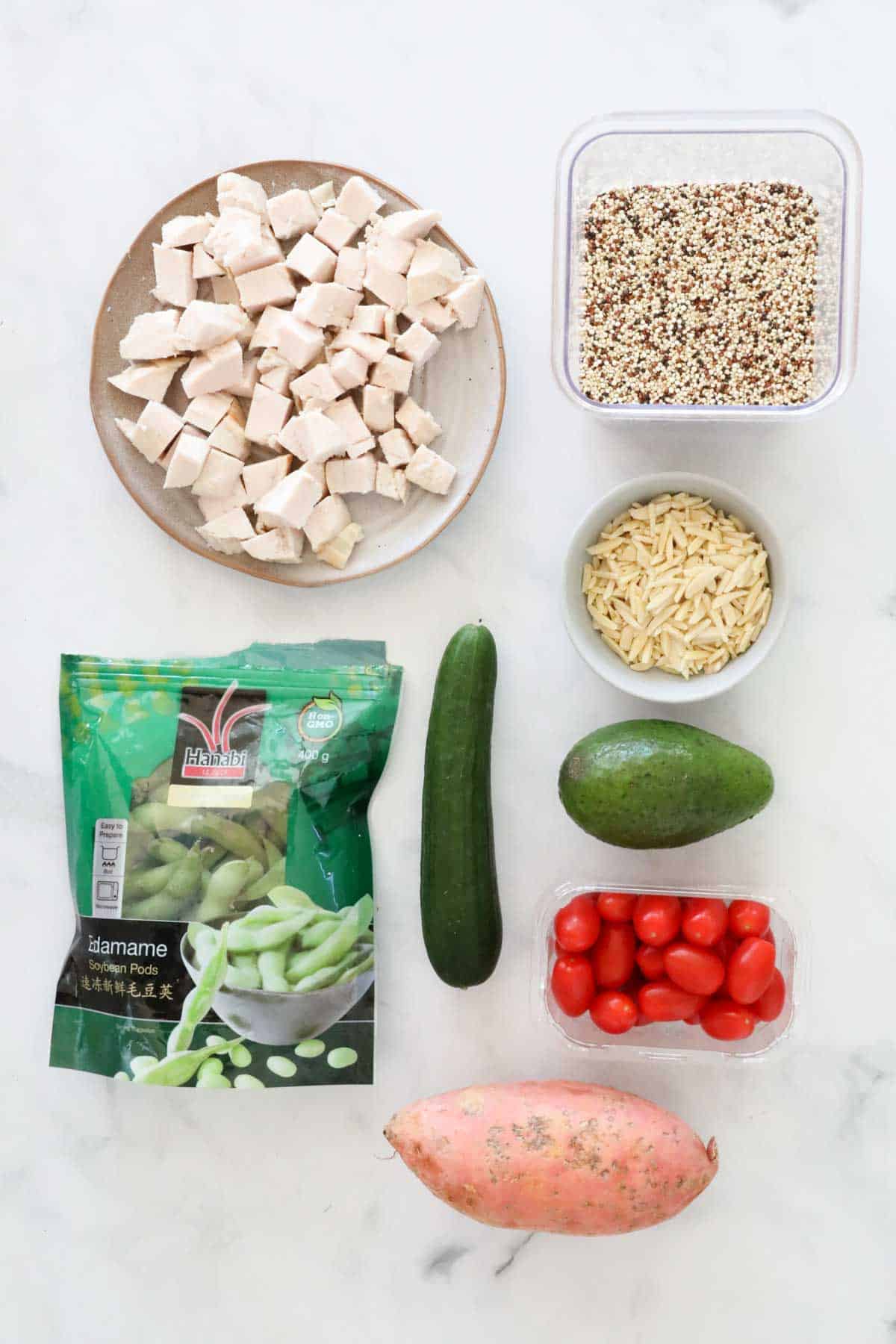 Ingredients needed for the quinoa chicken bowls weighed out and placed in individual bowls.