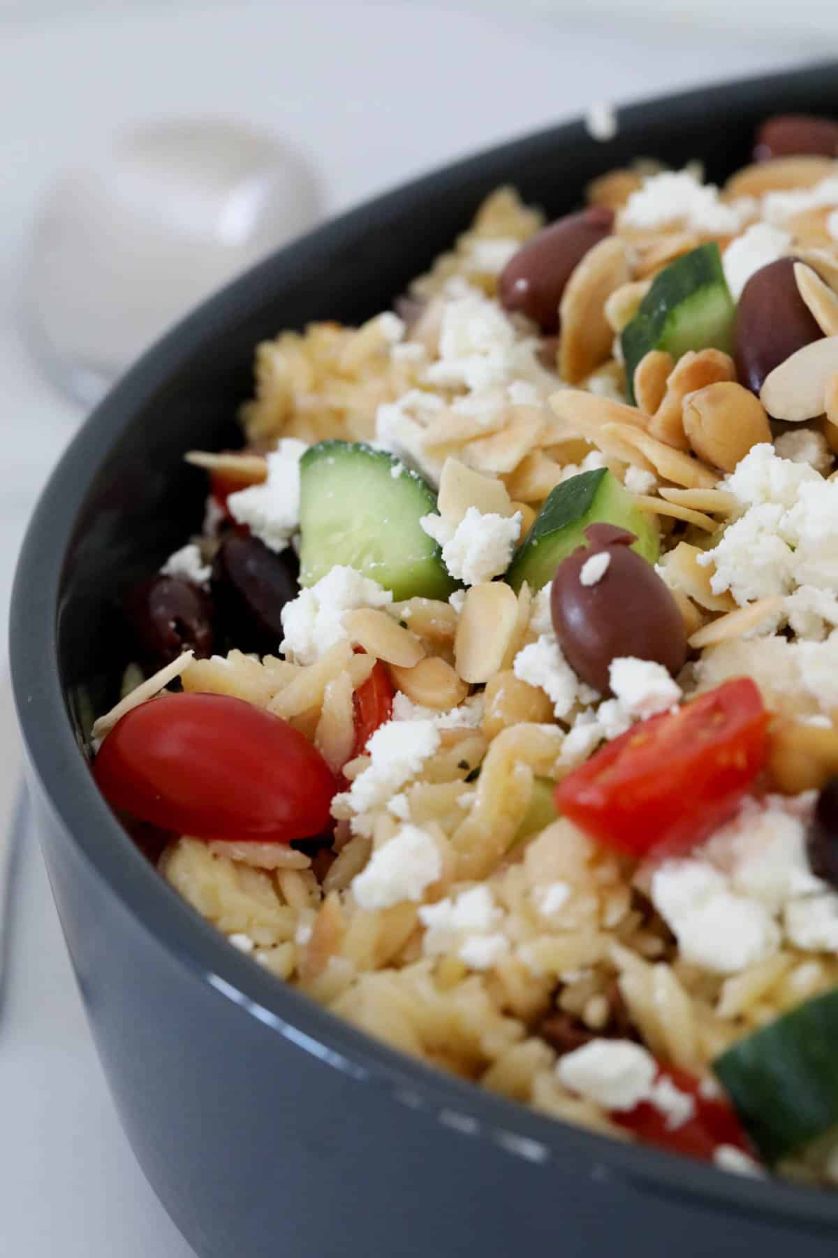 Close up of risoni salad in a serving bowl.