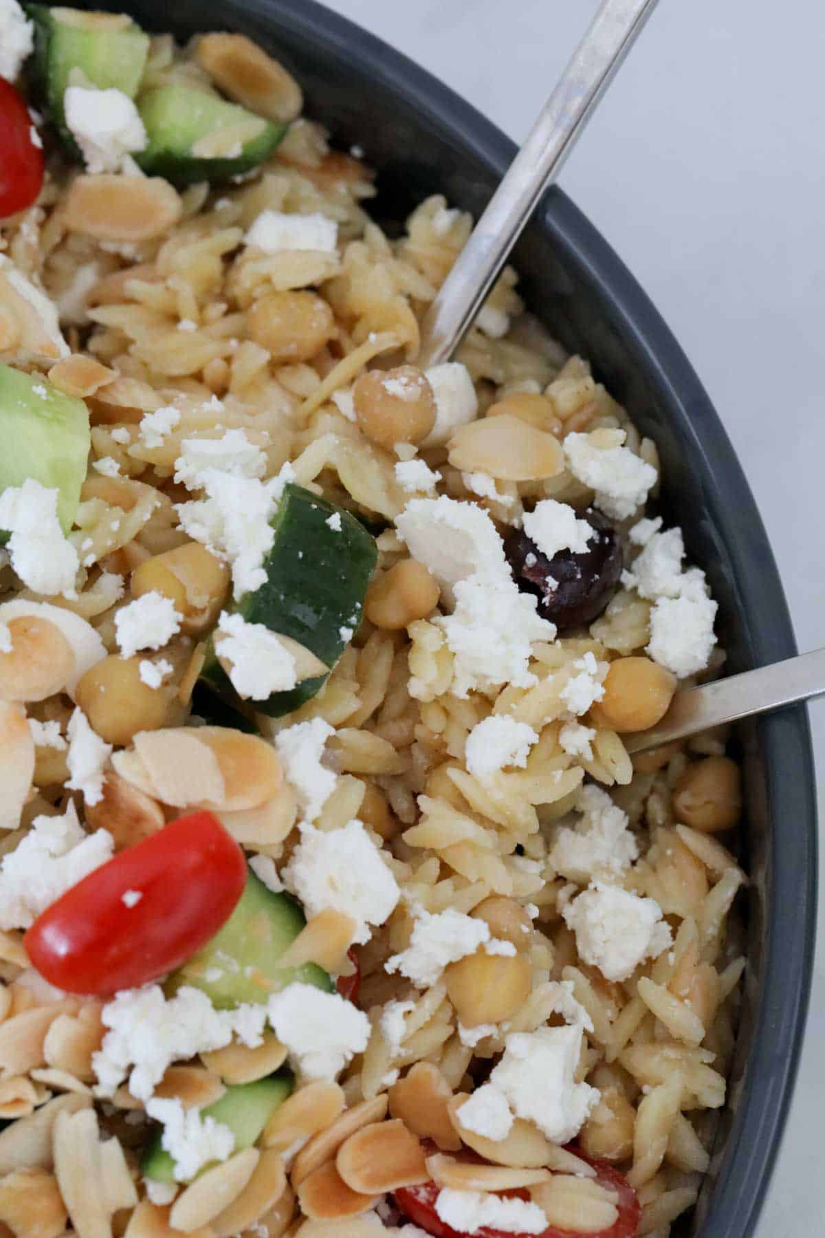 Overhead shot of a healthy grain salad with crumbled feta on top.