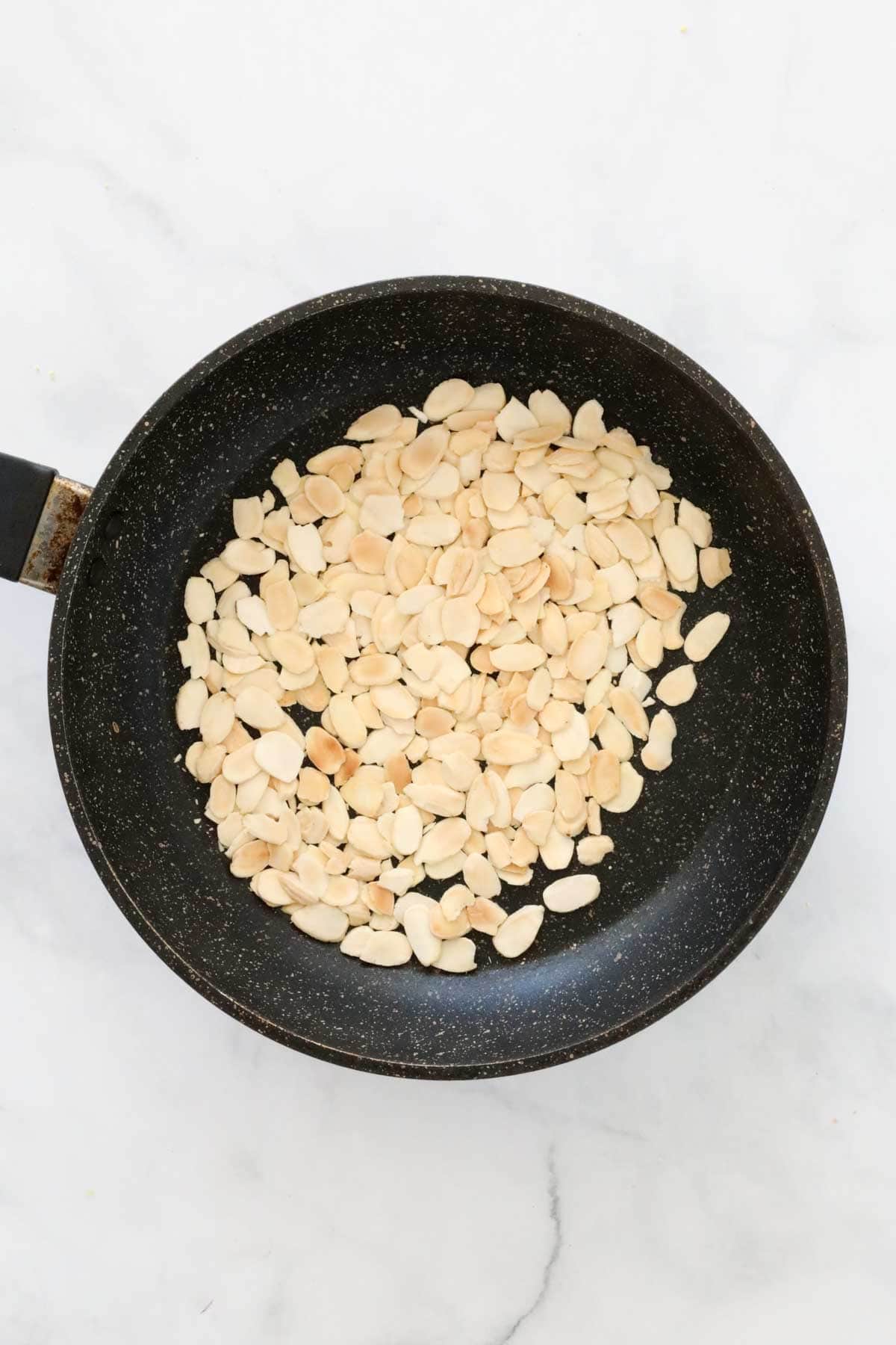 Flaked almonds toasted until golden in a small frying pan.