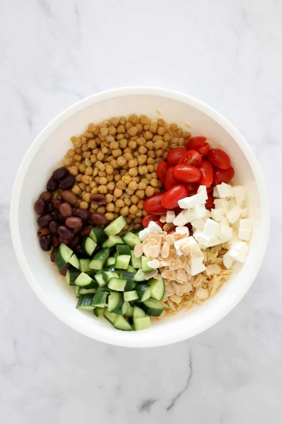 The other salad ingredients added to the bowl.