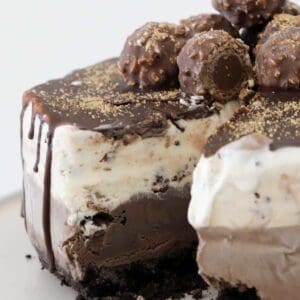 A triple layer chocolate Ferrero Rocher Ice Cream Cake with ice magic on top.