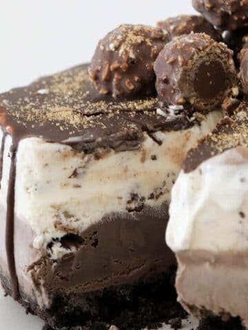 A triple layer chocolate Ferrero Rocher Ice Cream Cake with ice magic on top.