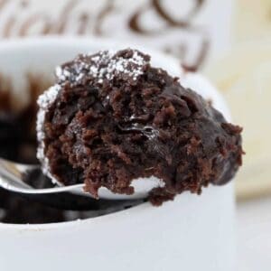 A spoonful of a rich chocolate mug cake.