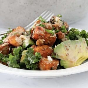 A plate of creamy kale, sweet potato, avocado and chickpea salad.