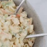 A bowl of creamy pasta salad with chunks of chicken.