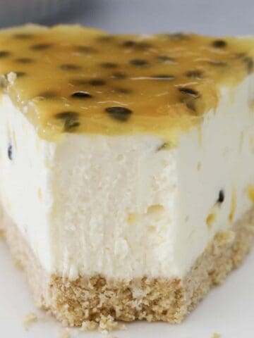 A half eaten slice of no bake passionfruit cheesecake.