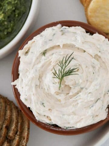 A bowl of homemade smoked salmon dip with crackers.