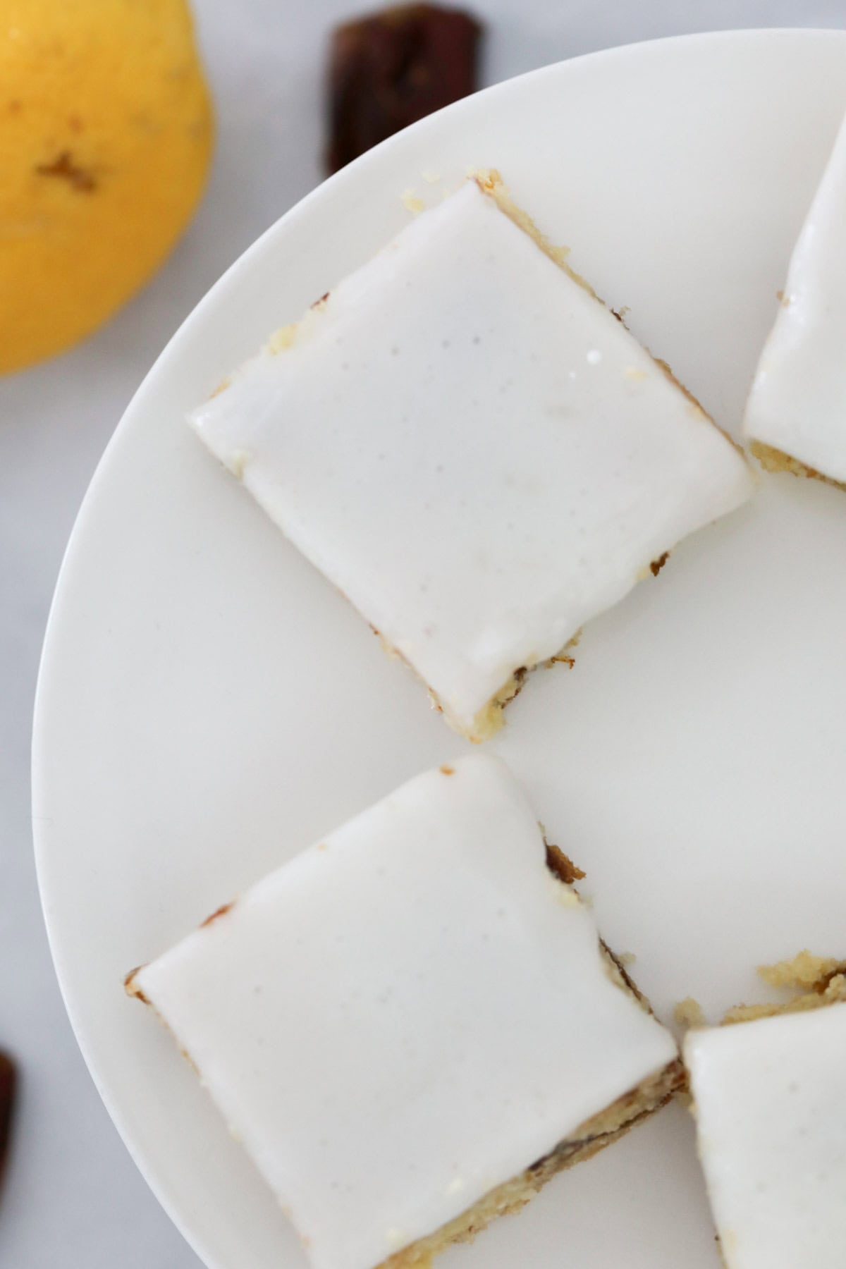 Overhead view of squares of slice with a thin lemon glaze.