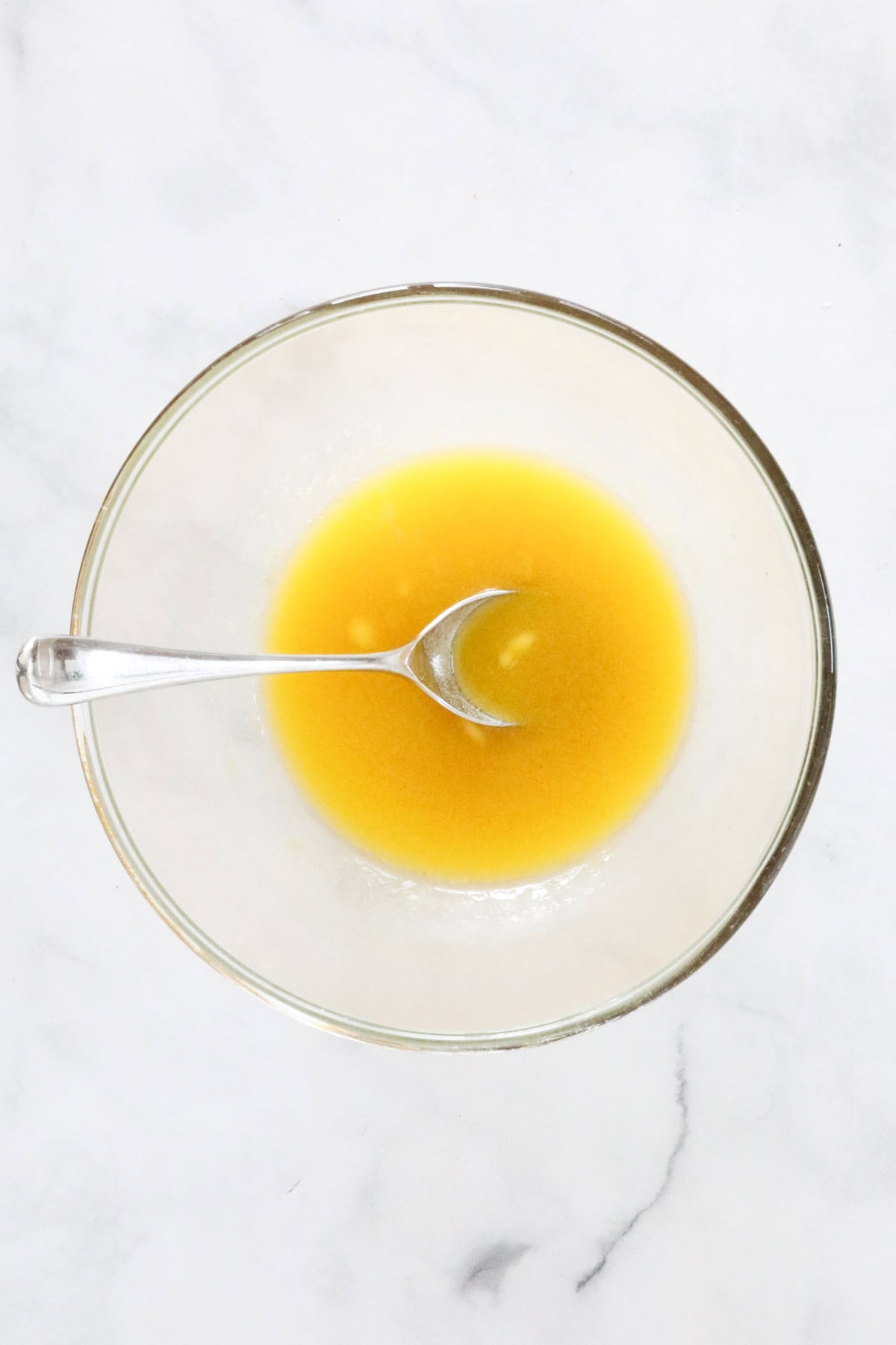 Melted butter and golden syrup in a glass bowl.