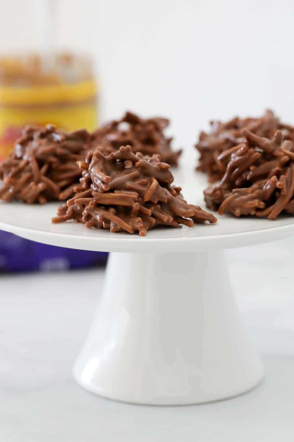 Classic choc spiders served on a white cake stand.