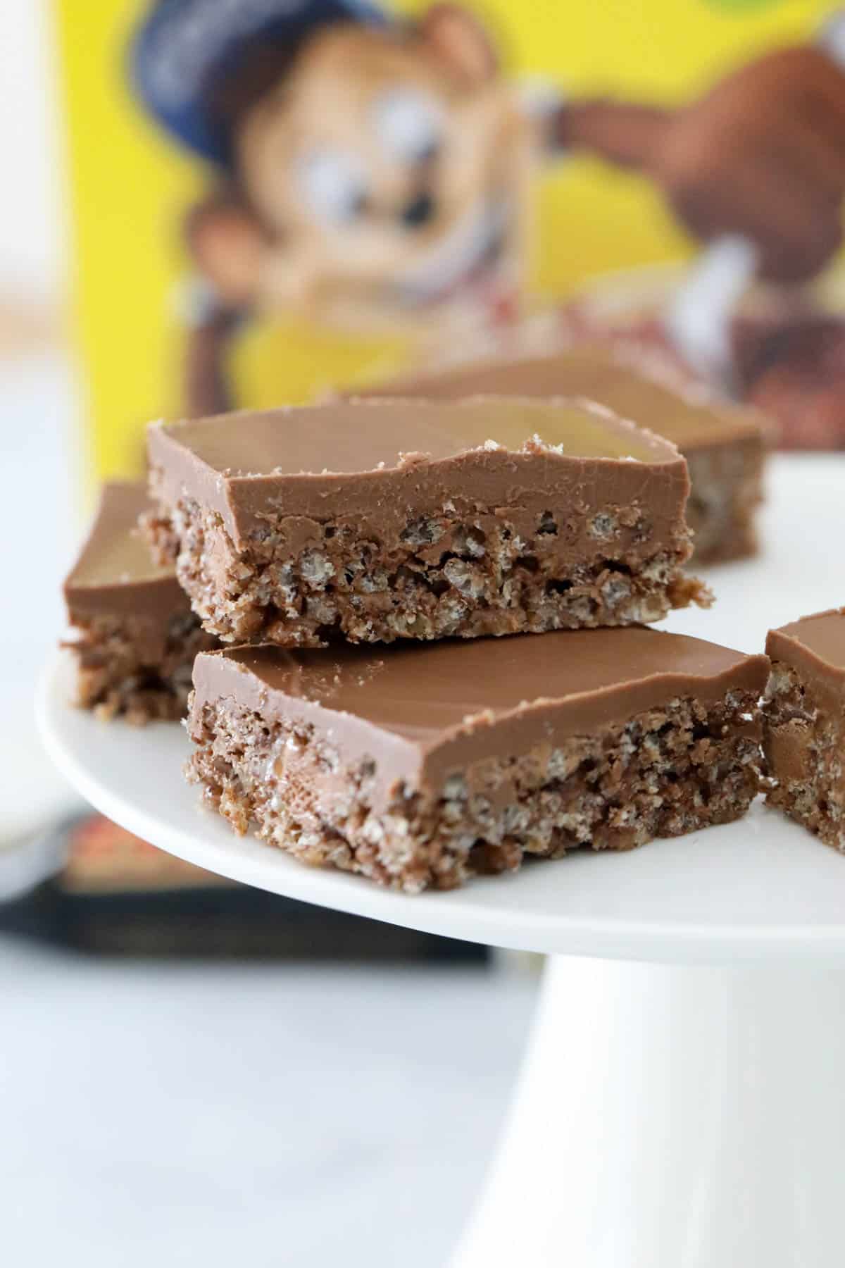 Bars of Coco Pop Mars Bar slice on a white cake stand.