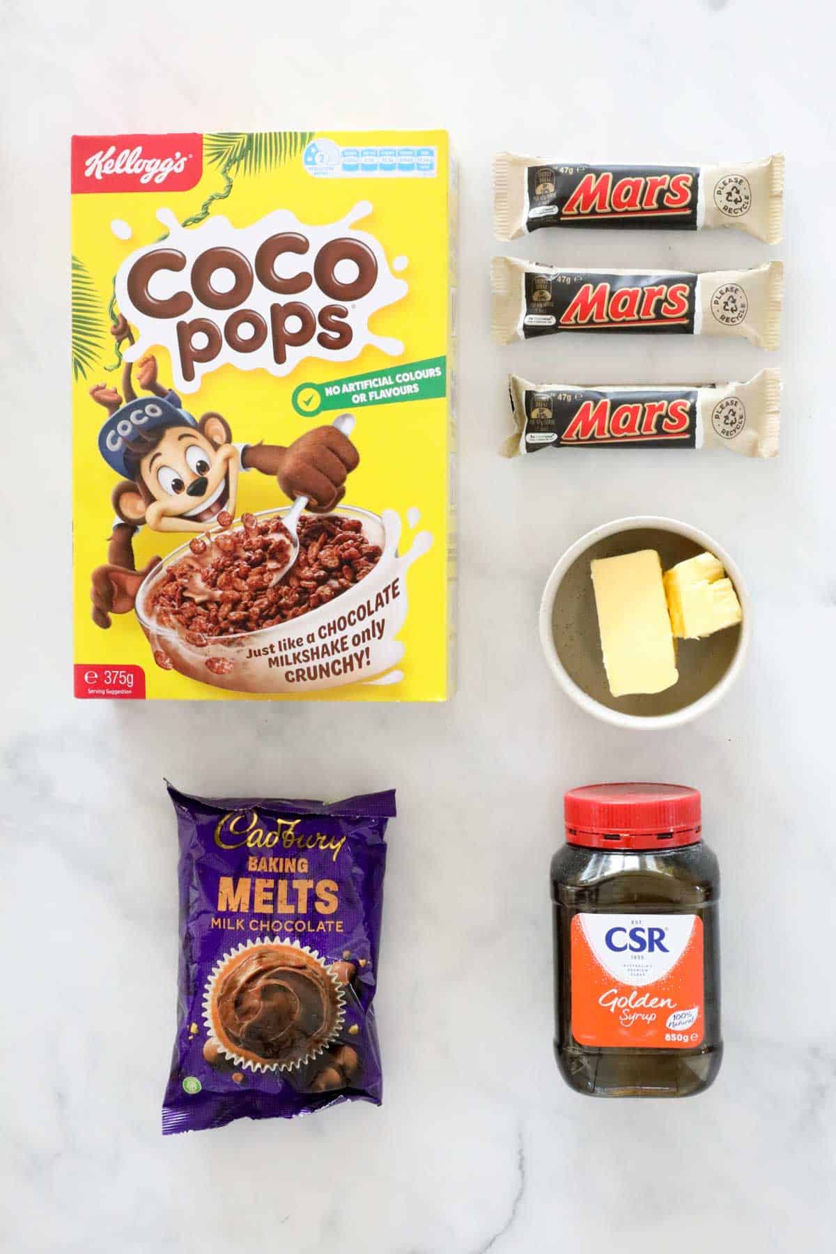 Ingredients required for a no-bake chocolate slice, placed on a bench.