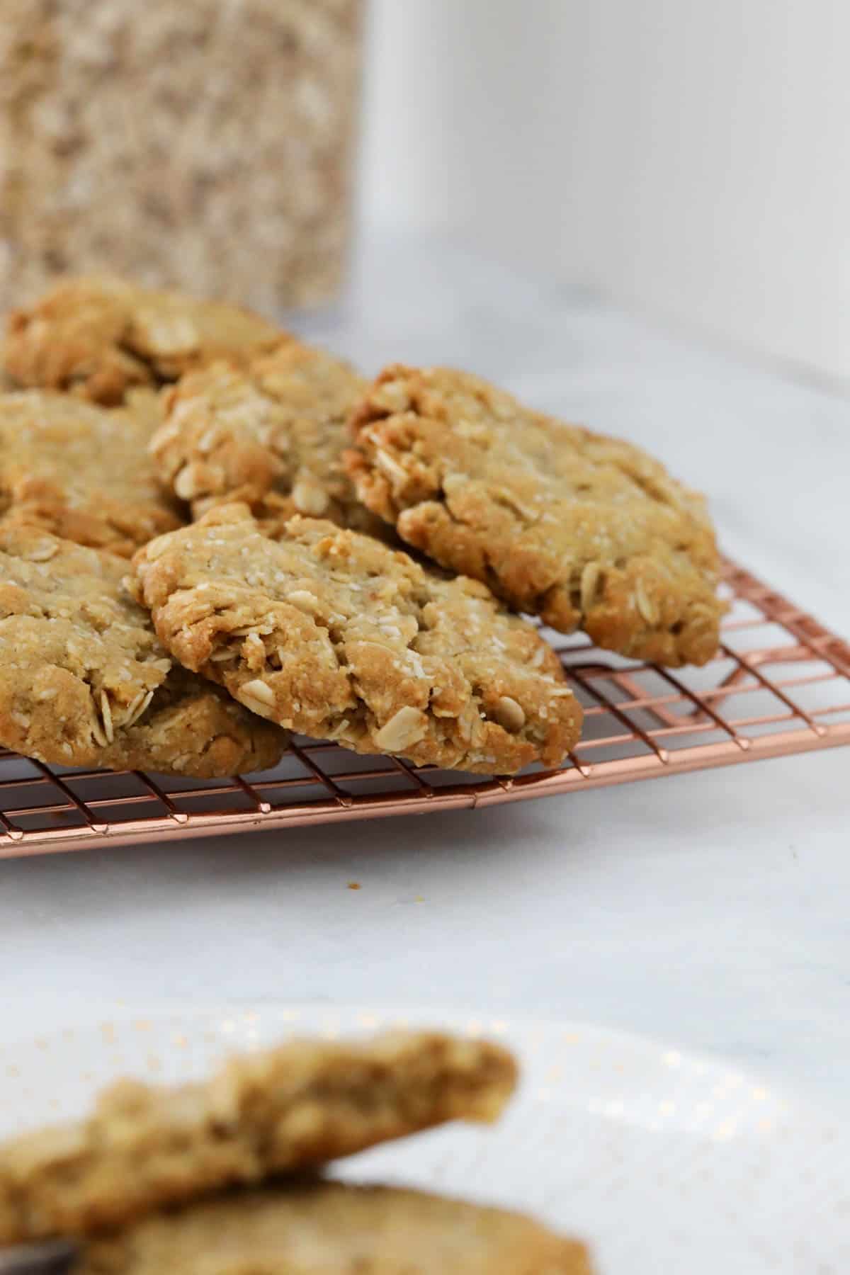 Oat cookies on a copper wire tray.