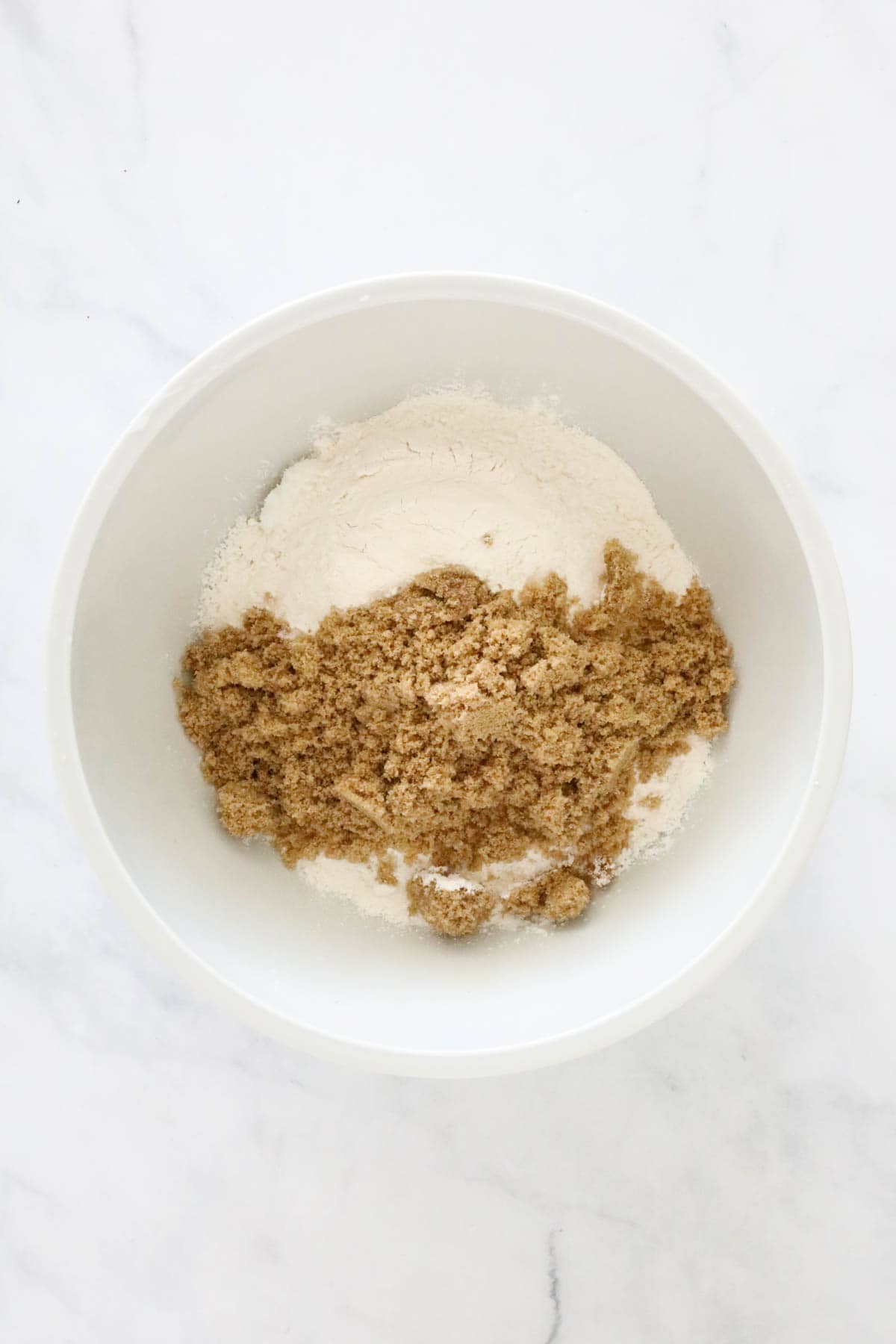 Dry ingredients placed in a large white mixing bowl.