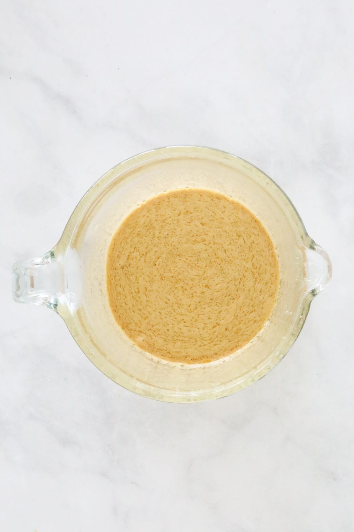 A fothy butter mixture after the bicarbonate of soda added.