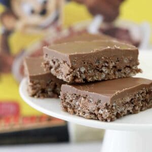 Bars of Coco Pop Mars Bar slice on a white cake stand.