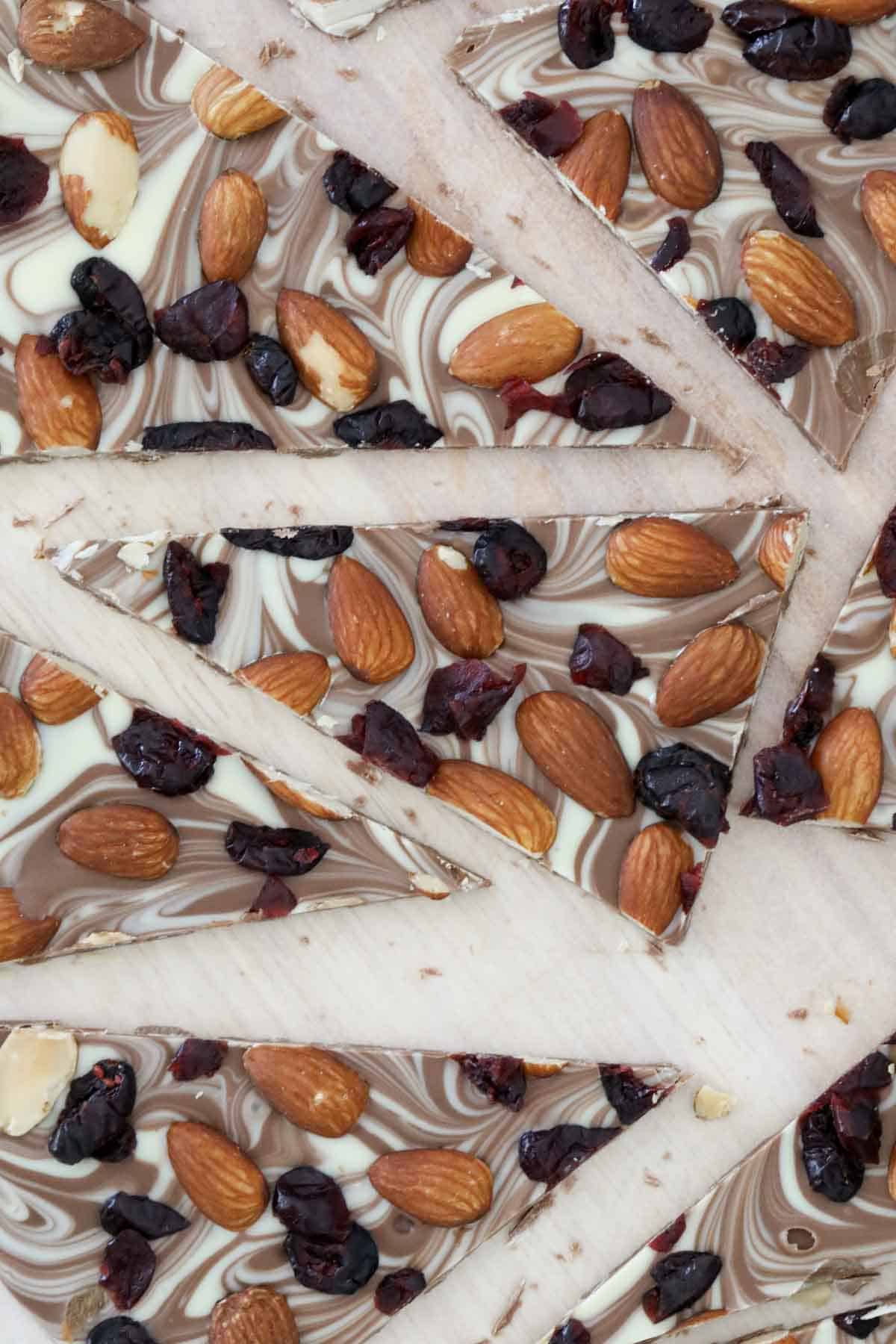 Overhead shot of triangles of chocolate, fruit and nut bark.