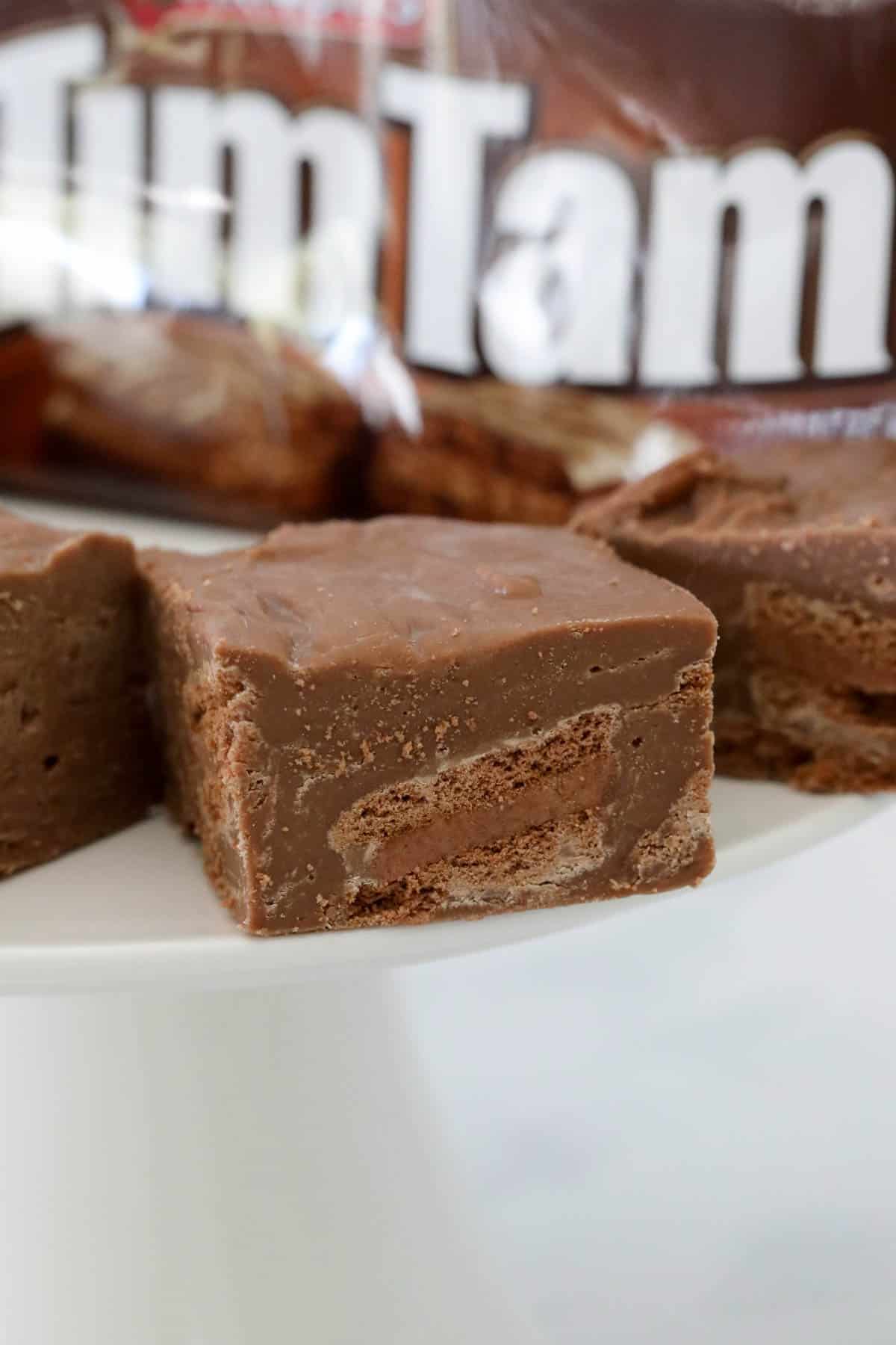 Squares of fudge on a white cake stand.