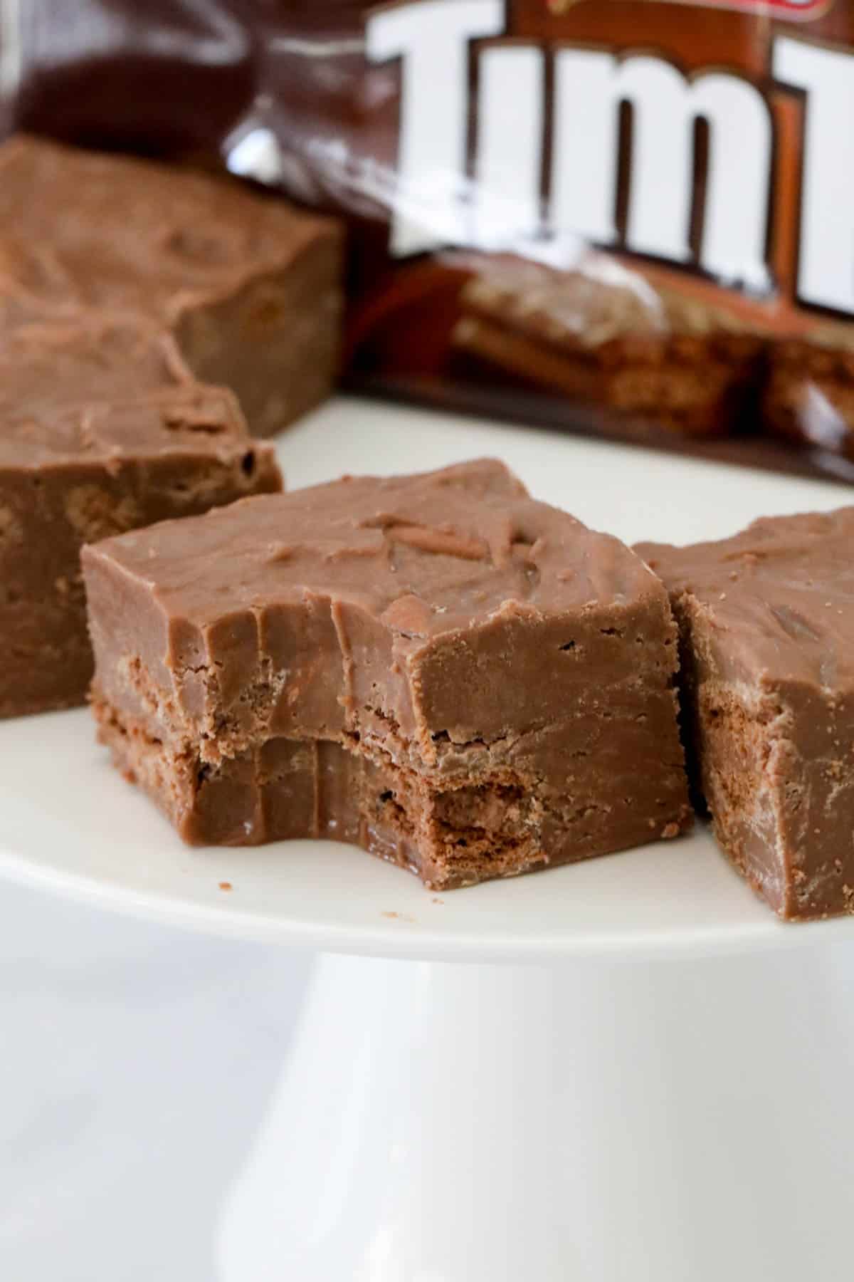 Pieces of Tim Tam fudge with a bite taken out of one piece at the front.