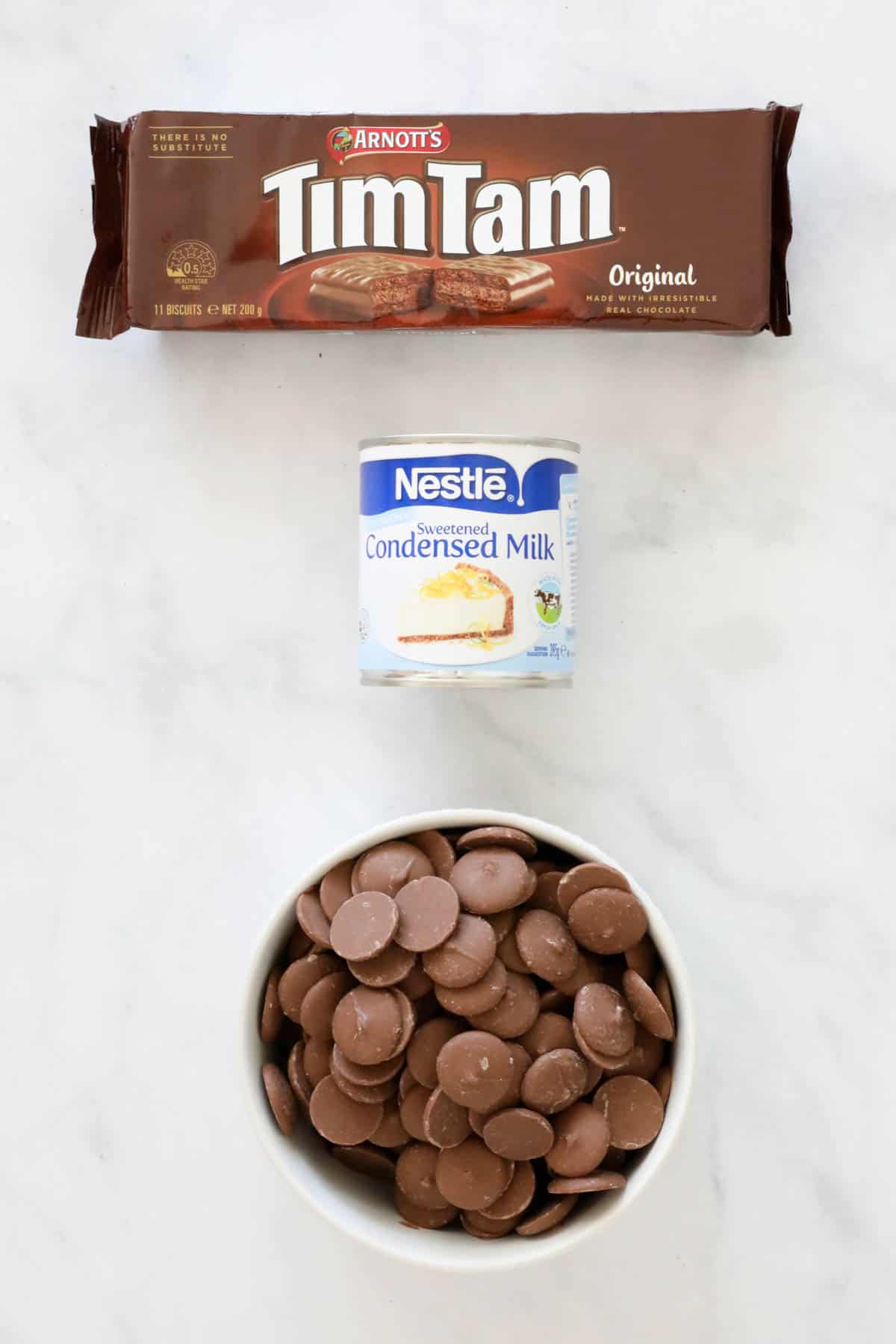 The 3 ingredients needed for fudge recipe, placed on a bench.