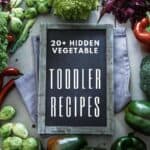 A board with the words 'Toddler Recipes with Hidden Vegetables' and vegetables around it.