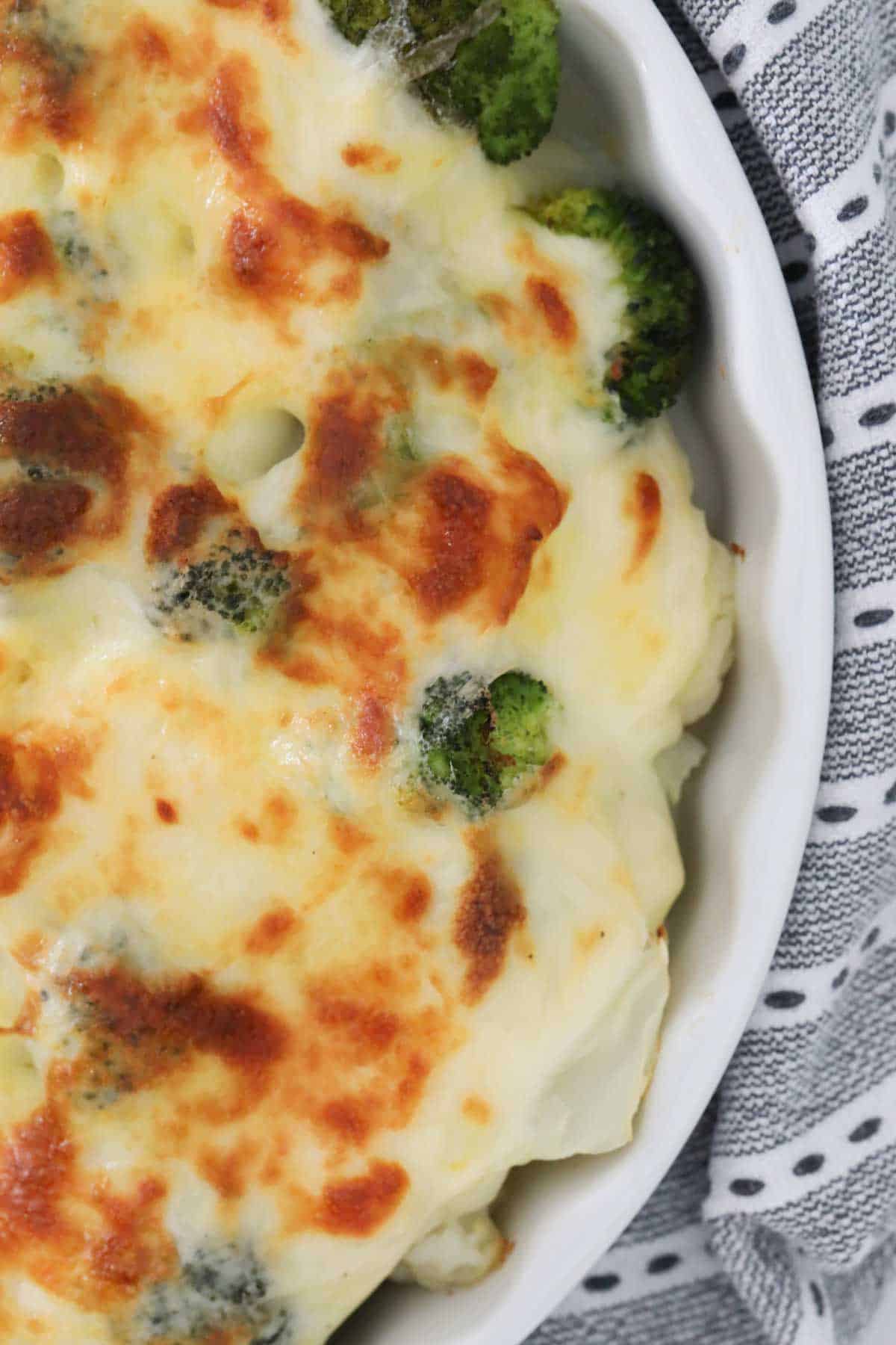 An overhead shot looking down on a golden cheese topped veggie bake.