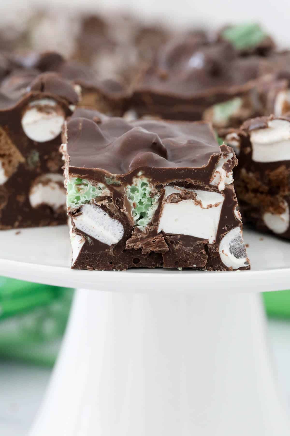 A close up of a piece of chocolate and mint rocky road.