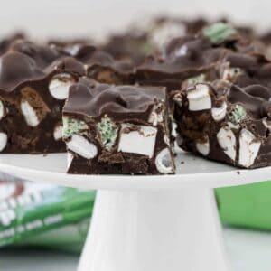 Pieces of Mint Rocky Road on a white cake stand.