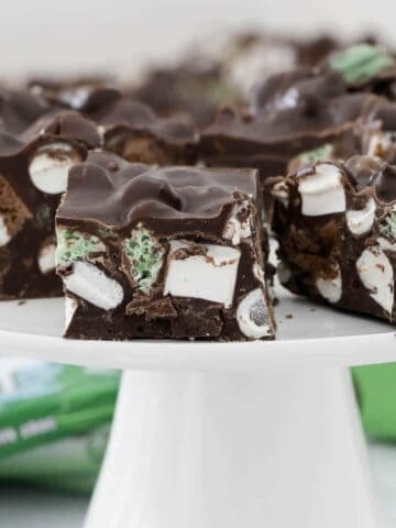 Pieces of Mint Rocky Road on a white cake stand.