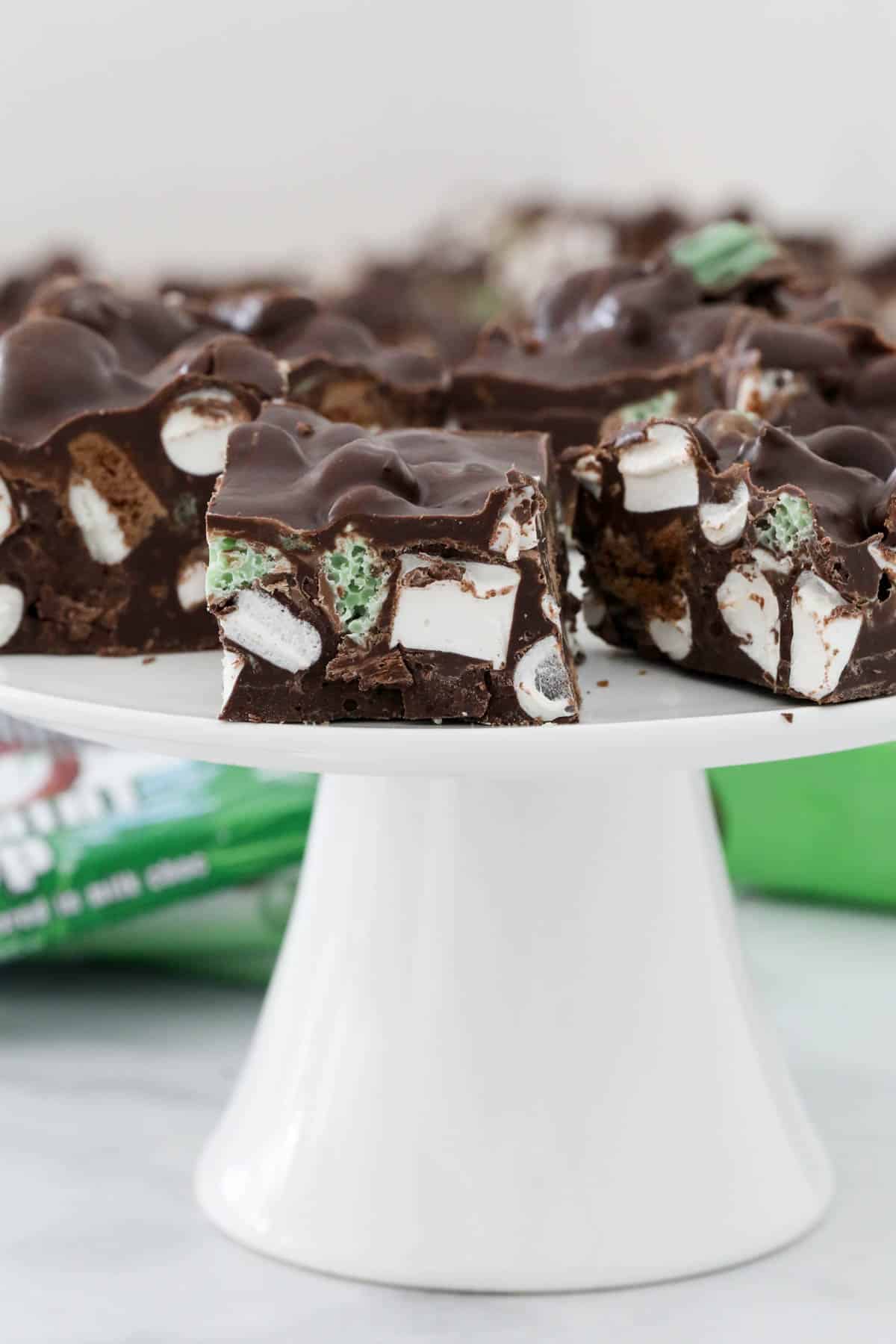 Pieces of Mint Rocky Road on a white cake stand.