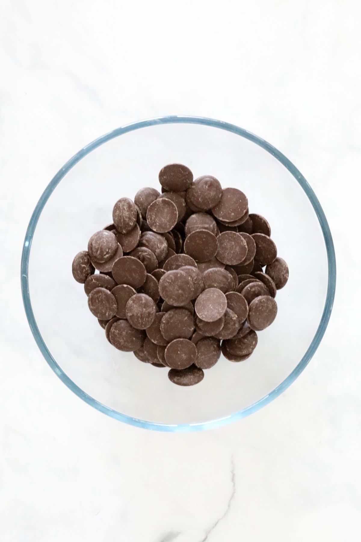 Chocolate melts in a glass microwave safe bowl.