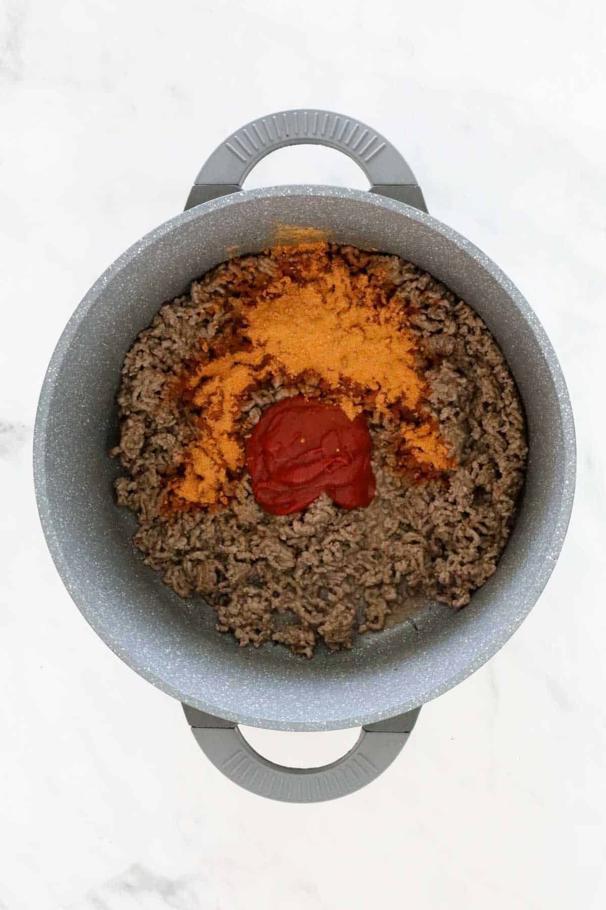 Taco seasoning and tomato paste added to the mince.