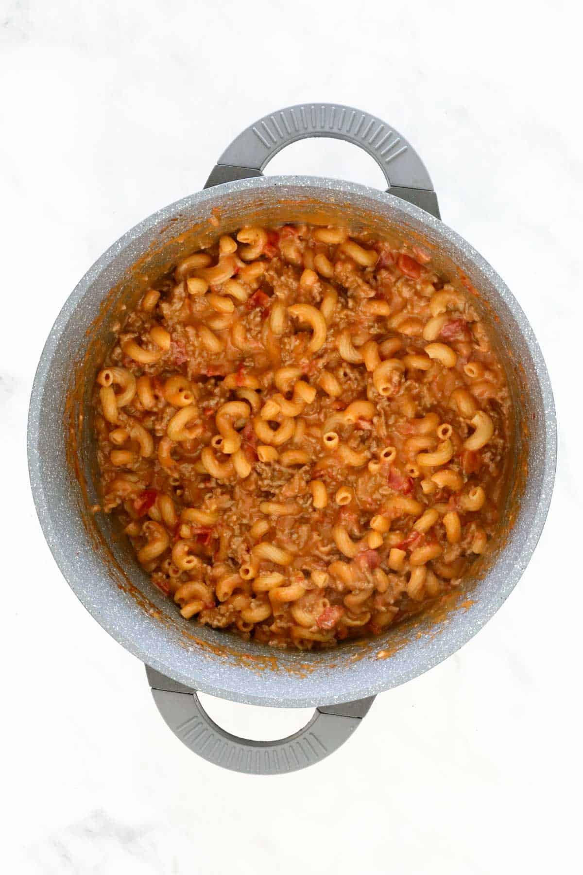 Taco Pasta with the cheese melted through the pasta and meat in the pan.